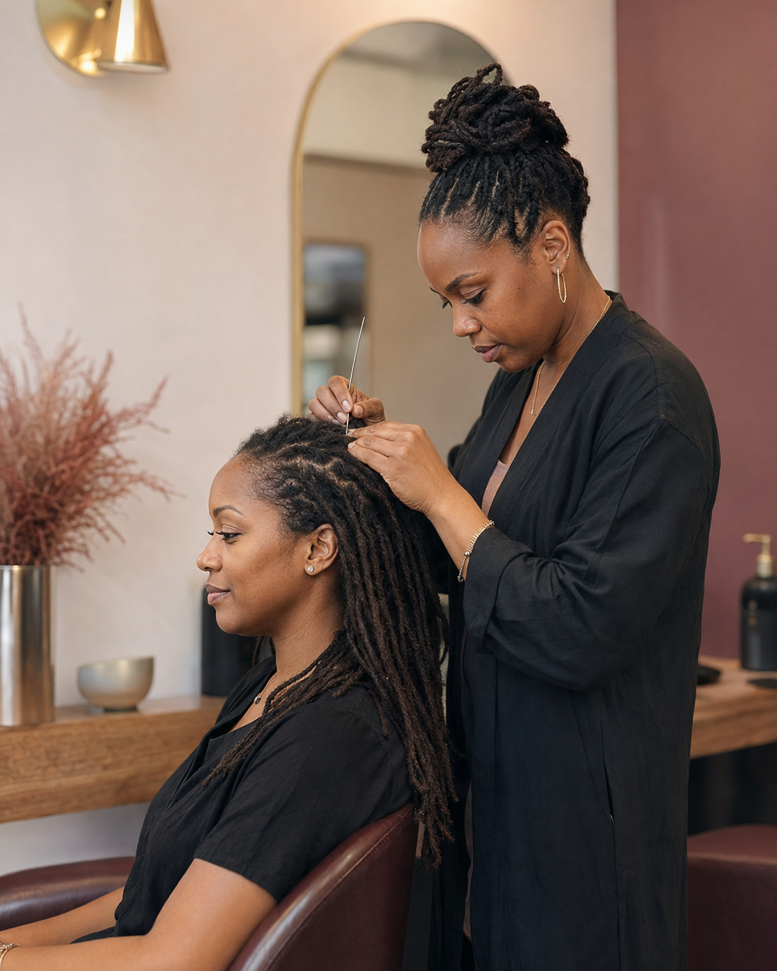 Experienced loctician completing a detailed salon service for a client